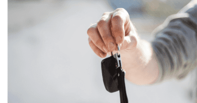 First-time buyer examining a used car with an inspection checklist